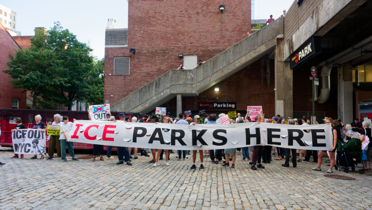 Demonstrators gather at the entrance to the ICON garage, behind a banner on Harrison Street that made their message clear. Photo: Carl Glassman/Tribeca Trib